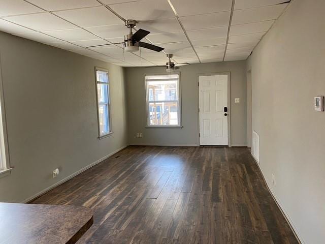 spare room featuring a paneled ceiling, ceiling fan, and dark hardwood / wood-style flooring