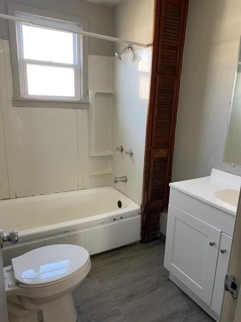 full bathroom featuring toilet, hardwood / wood-style floors, vanity, and tub / shower combination