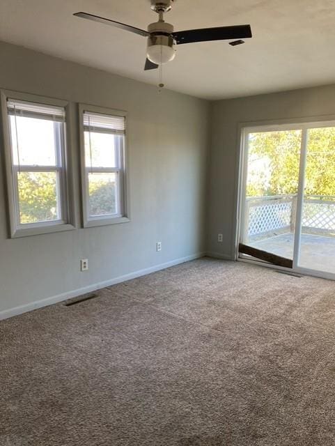 unfurnished room with carpet flooring and ceiling fan