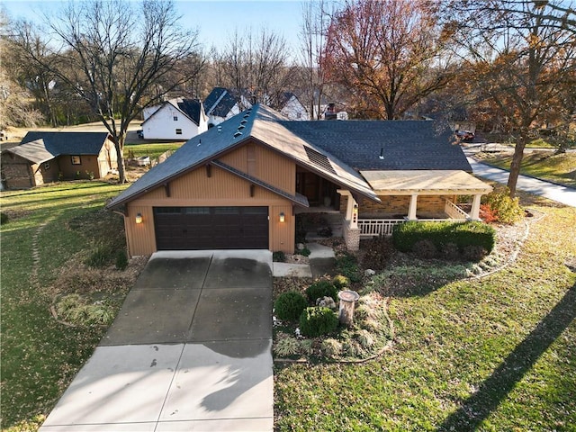 view of front of house featuring a front lawn, a porch, and a garage