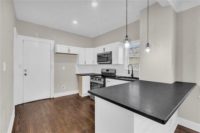 kitchen featuring pendant lighting, dark wood-type flooring, white cabinets, sink, and appliances with stainless steel finishes