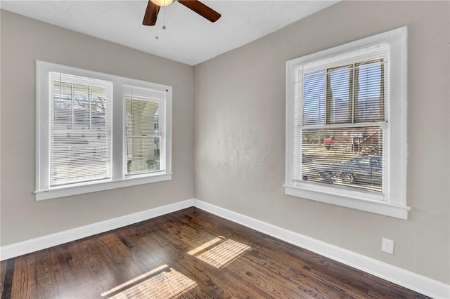 unfurnished room with dark hardwood / wood-style floors, a wealth of natural light, and ceiling fan