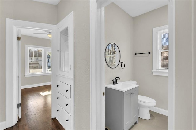 bathroom featuring vanity, hardwood / wood-style flooring, ceiling fan, and a healthy amount of sunlight