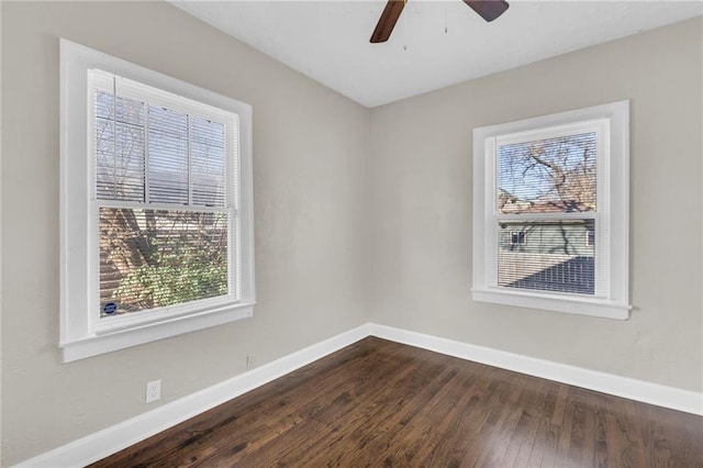 spare room with ceiling fan and dark wood-type flooring