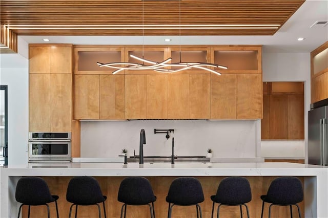 12604 W 160th St, Overland Park, KS 66062 - kitchen with appliances with stainless steel finishes, modern cabinets, a kitchen breakfast bar, a chandelier, and recessed lighting