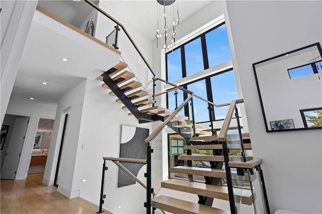 12604 W 160th St, Overland Park, KS 66062 - stairs featuring a towering ceiling, wood finished floors, and baseboards