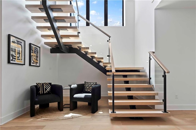12604 W 160th St, Overland Park, KS 66062 - stairway featuring baseboards, wood finished floors, and a towering ceiling