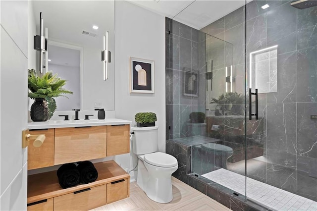 bathroom with walk in shower, vanity, and toilet