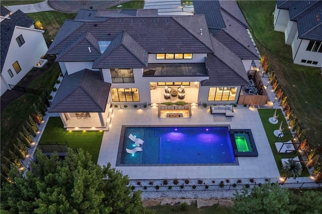 12604 W 160th St, Overland Park, KS 66062 - back of property with an outdoor hangout area, a fenced backyard, a patio area, and a pool with connected hot tub
