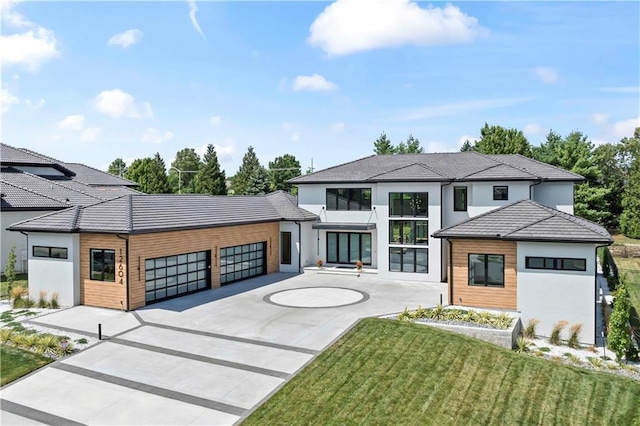 12604 W 160th St, Overland Park, KS 66062 - contemporary home with a garage, concrete driveway, a tile roof, stucco siding, and a front lawn