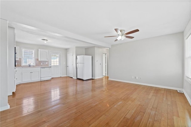 unfurnished living room featuring ceiling fan and light hardwood / wood-style floors