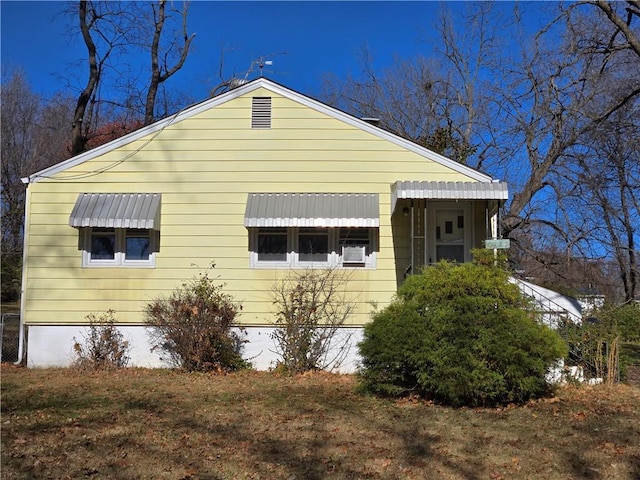 view of side of home featuring a yard