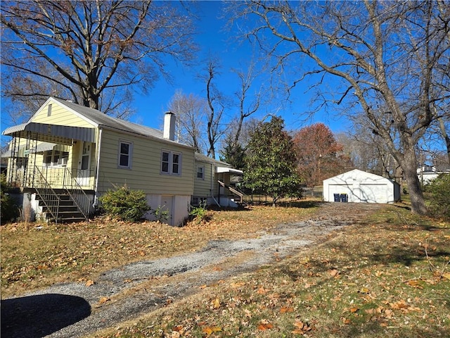 view of side of home featuring an outbuilding and a garage