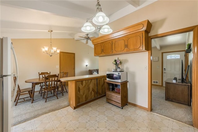 kitchen with visible vents, brown cabinets, a peninsula, a notable chandelier, and white appliances