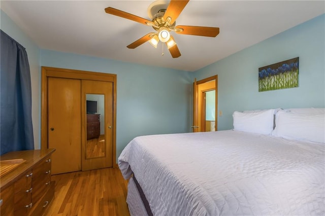 bedroom with a ceiling fan and wood finished floors