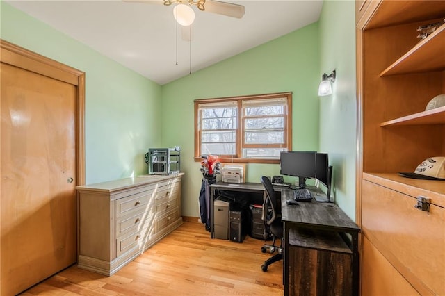 home office featuring light wood-style flooring, a ceiling fan, and vaulted ceiling