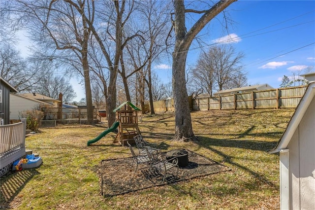 view of yard with a playground and a fenced backyard