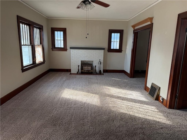 unfurnished living room featuring carpet, plenty of natural light, and crown molding