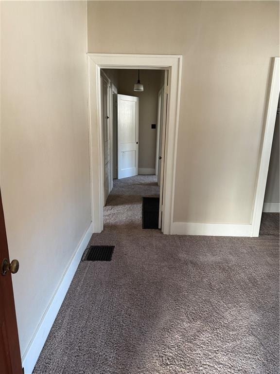 hallway with dark carpet