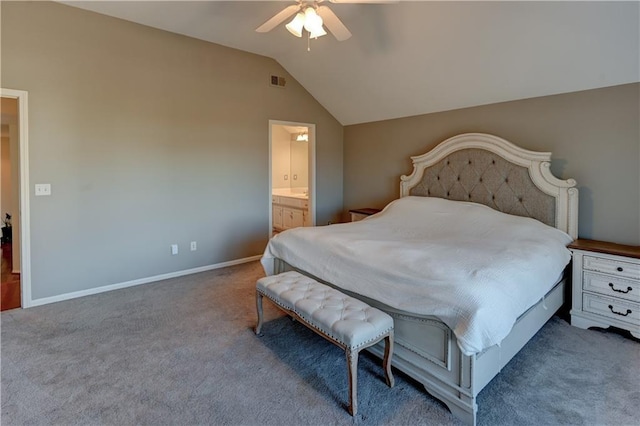 carpeted bedroom with ceiling fan, ensuite bathroom, and vaulted ceiling