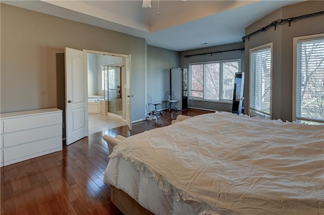 bedroom featuring hardwood / wood-style flooring and ensuite bath