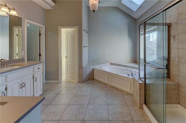 bathroom featuring tile patterned floors, separate shower and tub, vaulted ceiling with skylight, and vanity