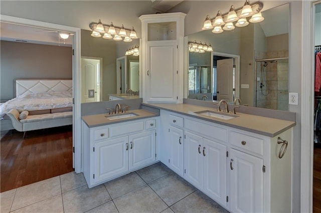 bathroom with tile patterned flooring, vanity, and a shower with shower door