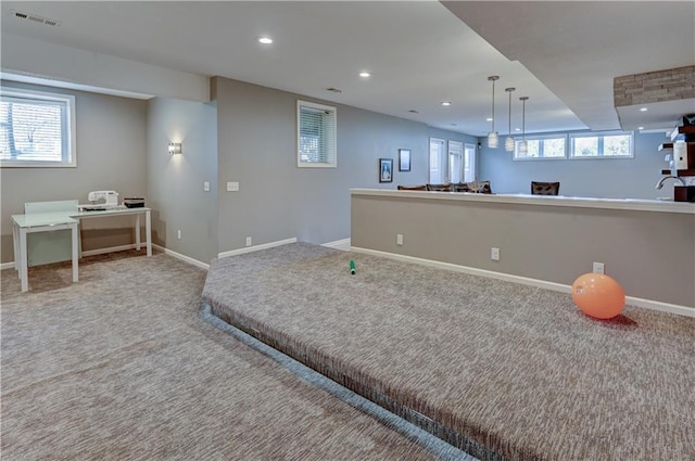 workout room featuring carpet flooring and a wealth of natural light