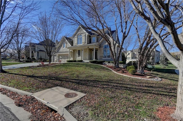 view of front of home with a porch, a garage, and a front lawn