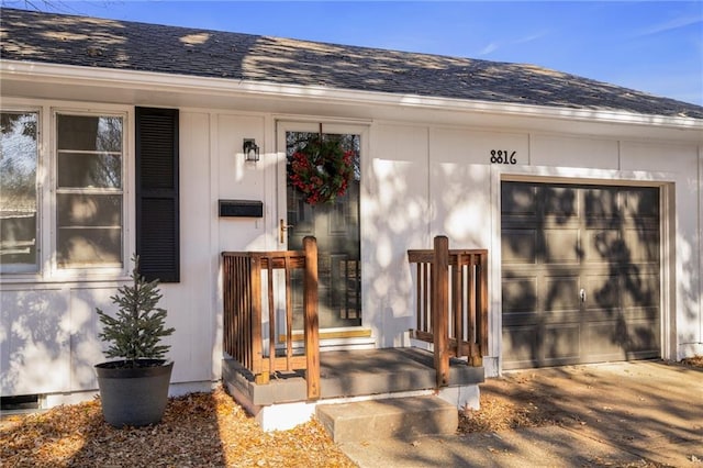 view of exterior entry with a garage