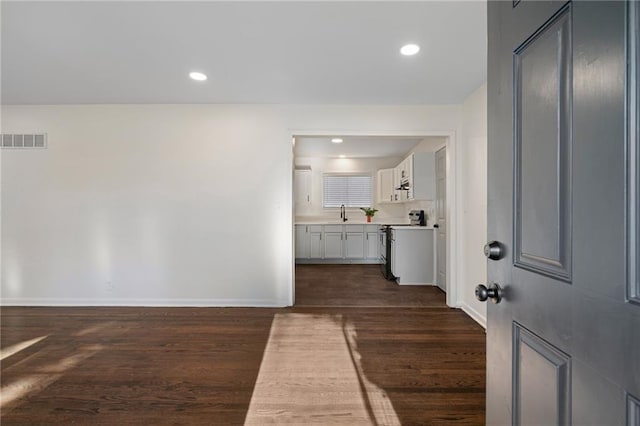 hall featuring sink and dark hardwood / wood-style floors