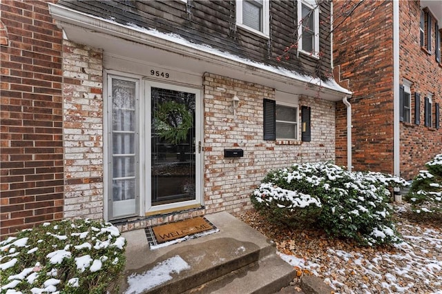 view of snow covered property entrance