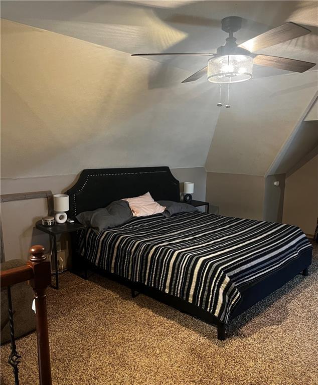 bedroom with carpet, ceiling fan, and lofted ceiling