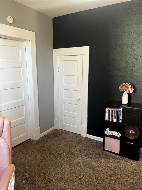 unfurnished bedroom featuring carpet flooring and a closet