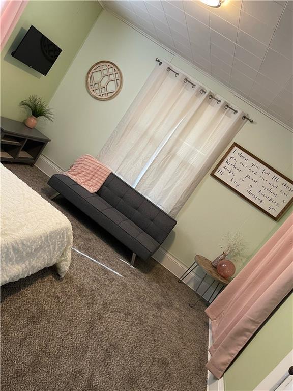 carpeted bedroom featuring lofted ceiling