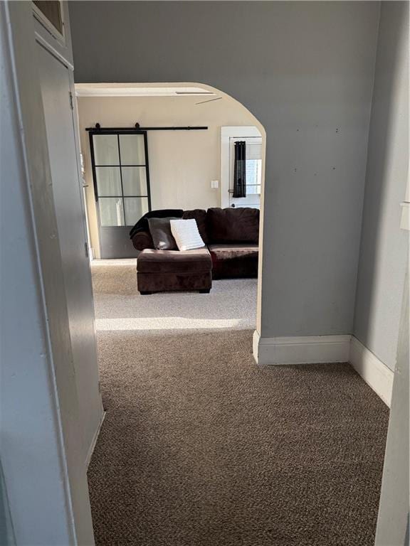 323 W 6th St, Chanute, KS 66720 - hallway featuring carpet floors, arched walkways, and baseboards