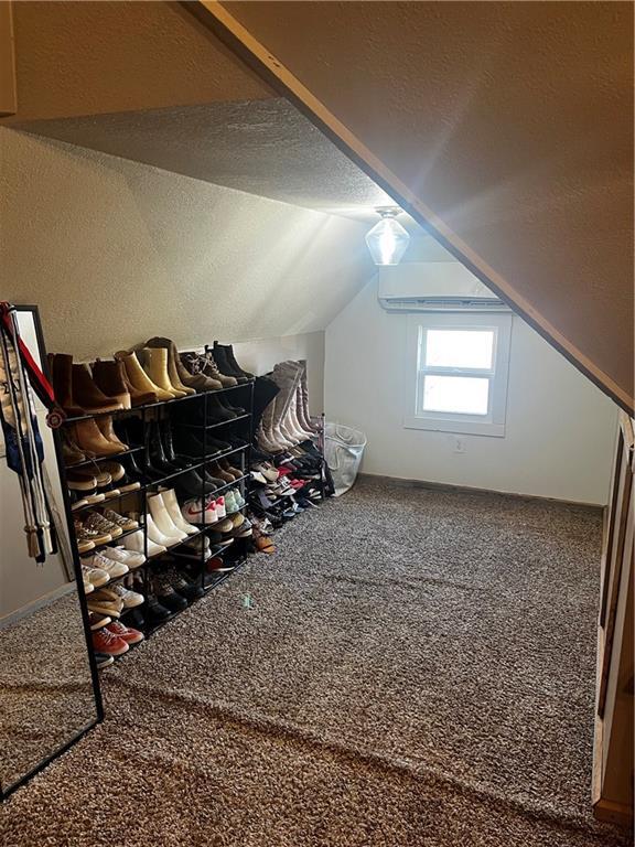 323 W 6th St, Chanute, KS 66720 - additional living space with carpet flooring and lofted ceiling