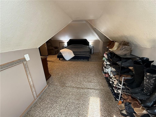 323 W 6th St, Chanute, KS 66720 - carpeted bedroom featuring a textured ceiling and lofted ceiling