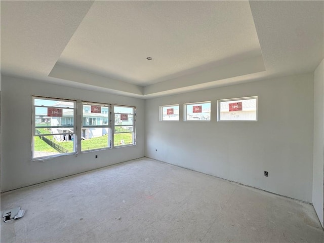 spare room with a tray ceiling
