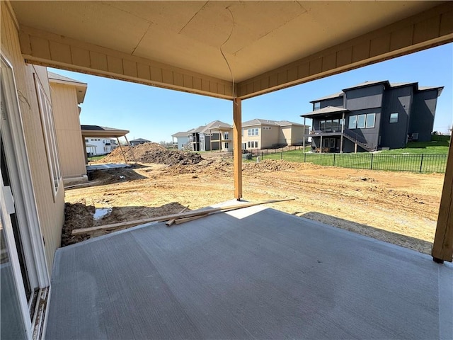 view of patio with a residential view and fence
