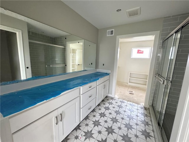 13408 W 178th St, Overland Park, KS 66013 - full bathroom with a stall shower, tile patterned floors, vanity, and a spacious closet