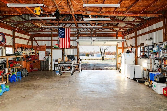 garage with a workshop area and a garage door opener