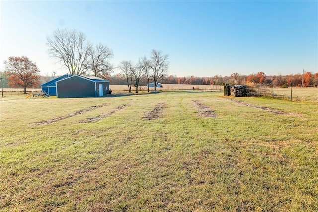 view of yard with an outbuilding and a rural view