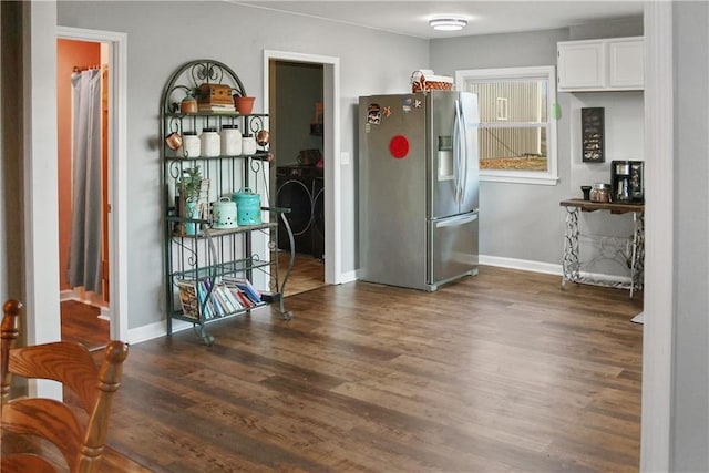 kitchen featuring white cabinets, stainless steel fridge with ice dispenser, and dark hardwood / wood-style flooring