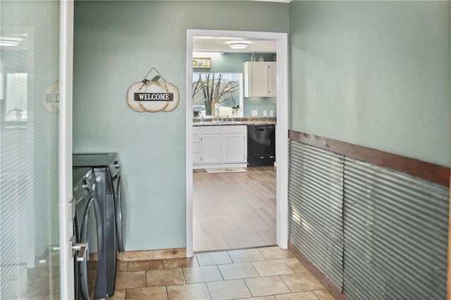 washroom with sink, light hardwood / wood-style flooring, and washer / dryer