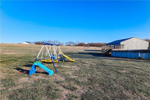 view of play area with a lawn and a rural view