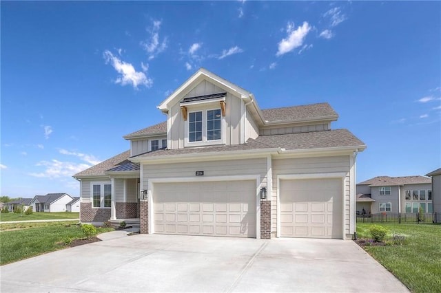 view of front of home with a front lawn and a garage