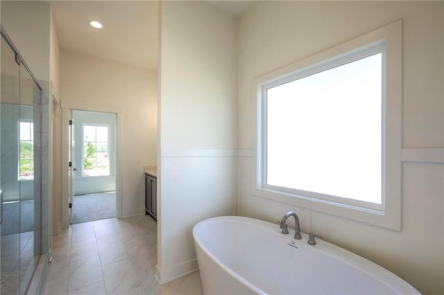 bathroom featuring shower with separate bathtub and vanity