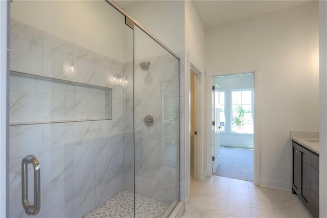 bathroom featuring vanity and a shower with shower door