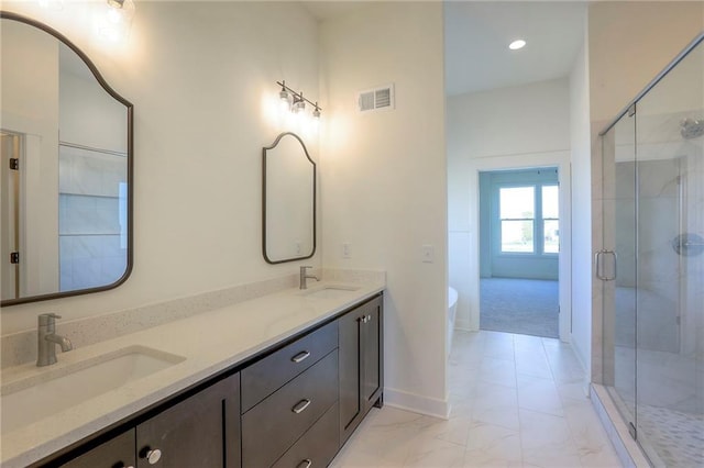 bathroom with vanity and independent shower and bath